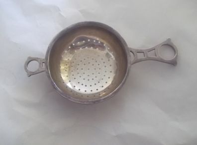 a solid  vintage silver strainer