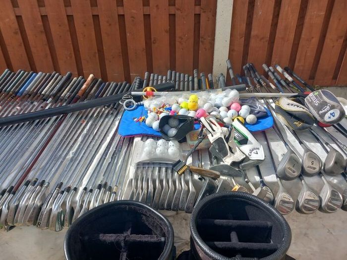 A selection of Golf clubs. Bags and golf balls.