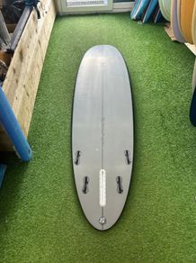 Second Hand Mark Phipps Surfboards 7'2 One Bad Egg Black Rails Grey Deck and Bottom FCS II Sides in