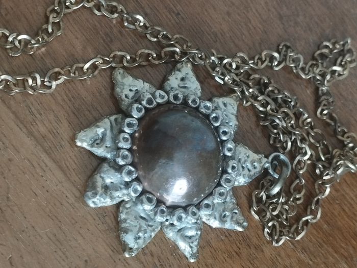Vintage pendant on a long chain.