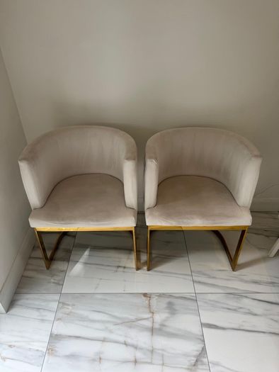 Cream and gold armchairs