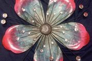 Decorative metallic flower with light reflecting effect