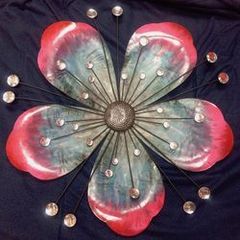 Decorative metallic flower with light reflecting effect