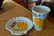 vintage ceramic cup and matching shell-shaped dish set featuring  cartoon yellow elephant "Sunny Funnies"