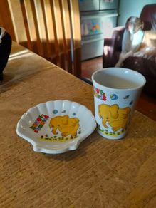 vintage ceramic cup and matching shell-shaped dish set featuring  cartoon yellow elephant "Sunny Funnies"