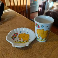 vintage ceramic cup and matching shell-shaped dish set featuring  cartoon yellow elephant "Sunny Funnies"