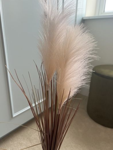 blue glass vase with fluffy reeds