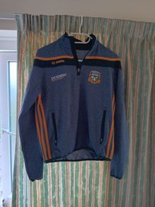 O'Neills Meath GAA Zip Top. Age 13. Width 47cm, Length 54cm. Very Good Condition. Price Includes Postage.