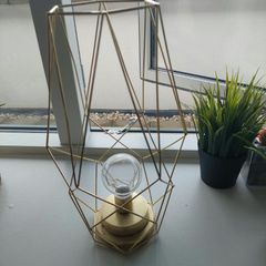 Geometric gold wire lantern lamp and two artificial grass plants