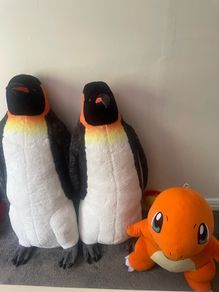 Two large penguins and dinosaur