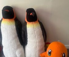 Two large penguins and dinosaur