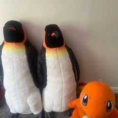 Two large penguins and dinosaur