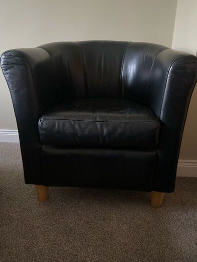 Large black leather barrel chair