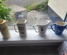 Four whisky advertising water jugs