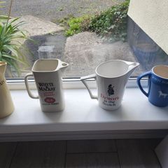 Four whisky advertising water jugs
