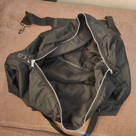 Large black expandable travel bag with shoulder strap