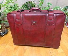 Vintage burgundy faux-leather suitcase