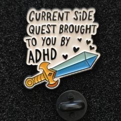 Sidequest , pin back badge.