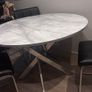 Round marble-effect dining table with 4 black chairs Image 3