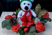 Christmas basket with teddy bear and artificial flowers