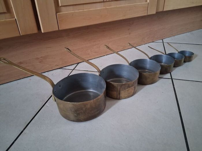 Graduated set French tinned Brass Pots and pans