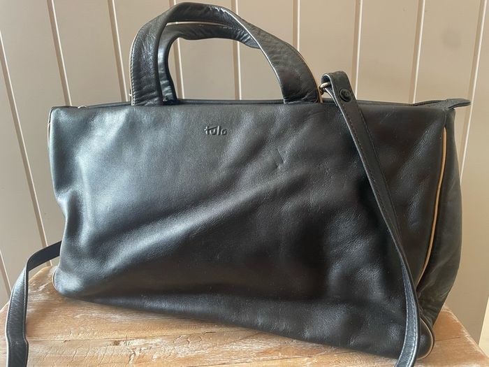 Tula black leather tote bag with a shoulder strap.