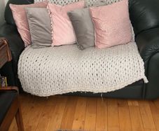 Green sofa with throw and cushions