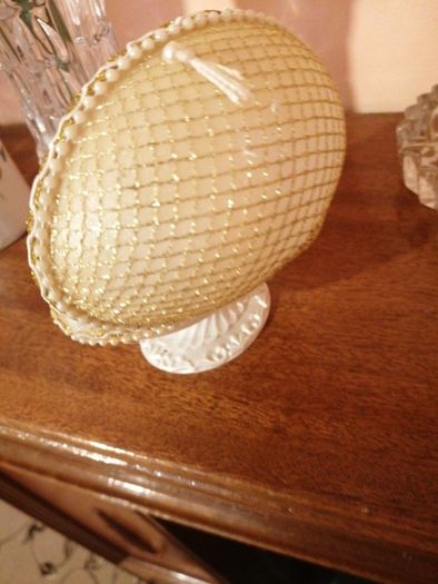 Glass hug bear in a shell case.