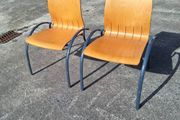 Two sturdy metal and wooden chairs