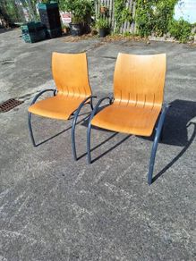 Two sturdy metal and wooden chairs