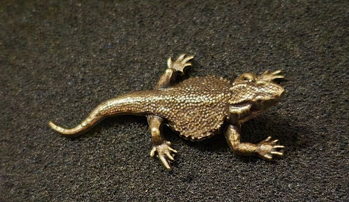3 brass lizards.