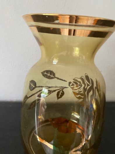 Vintage glass vase with gold decorations.