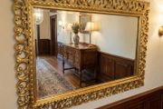 Carved wood framed decorative but simple mirror