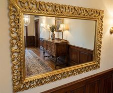 Carved wood framed decorative but simple mirror