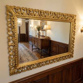 Carved wood framed decorative but simple mirror