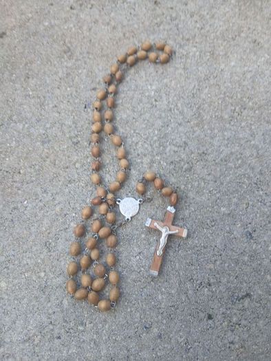 Title: Authentic Jerusalem Olive Wood Rosary & Leather Case  Description: Selling an authentic Catholic rosary made from Holy Land olive wood beads. The back of the crucifix is stamped "JERUSALEM", and the center medal is stamped "TERRA SANTA" with a 