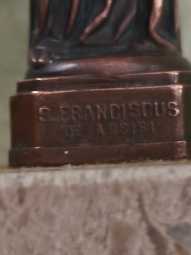 Copper Sacred art statue of Saint Francis of Assisi on marble plinth.