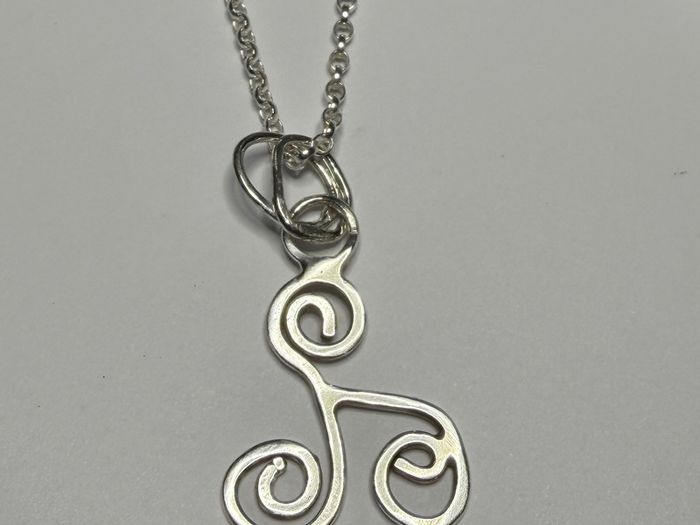 Sterling silver Triskele pendant on 18 or 20 inch chain.