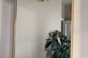 Gold framed mirror with integrated light vanity