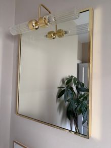 Gold framed mirror with integrated light vanity
