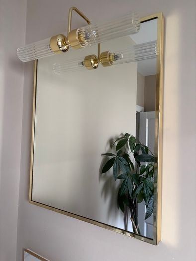 Gold framed mirror with integrated light vanity
