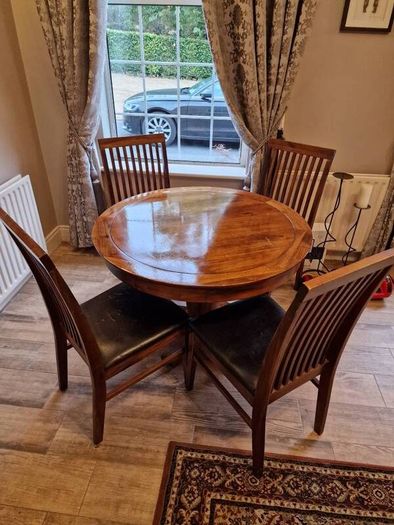 Round wooden table and four chairs