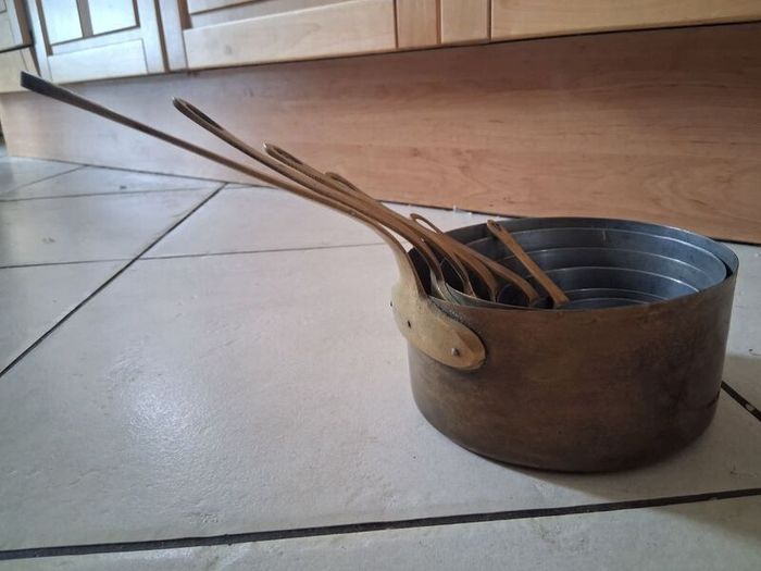 Graduated set French tinned Brass Pots and pans