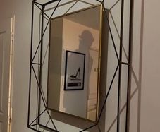 Geometric wall mirror with a metal frame