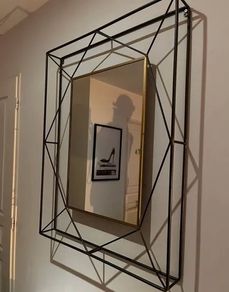 Geometric wall mirror with a metal frame