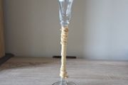 A tall clear glass candle holder