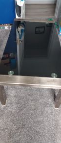 Glass black coffee table with silver legs