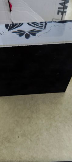 2 Papper Weight , Brass Papper Weight marked ISLAND 12.00 euro. Cleare Risen Tile Papper Weight.with black velvet on the back.10.00 euro.