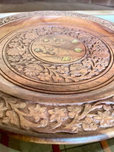 Beautiful vintage hand-carved wooden tray featuring an intricate floral border and a decorative brass inlay geometric star motif in the centre. The craftsmanship is detailed and very tactile, giving this piece a rich, warm character. The tray is solid and