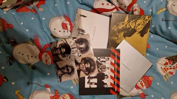 bag of U2 promo CD singles, CD albums and DVD sets